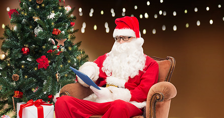 Image showing santa claus with tablet pc and christmas tree