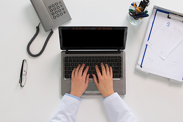 Image showing woman doctor hands typing on laptop at clinic