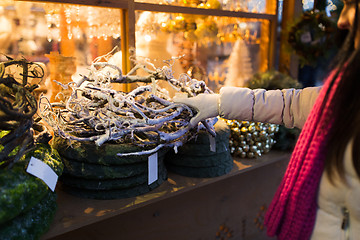 Image showing woman with branch wreath at christmas market