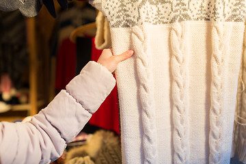 Image showing woman buying woolen clothes at christmas market