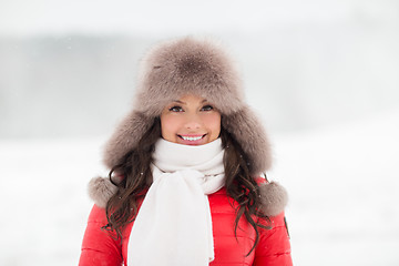 Image showing happy smiling woman in winter fur hat outdoors