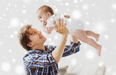 Image showing happy young father playing with baby at home