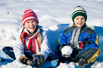 Image showing Happy little children playing  in winter snow day.