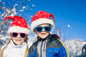 Image showing Happy little children playing  in winter snow day.