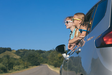 Image showing Happy brother and his two sisters are sitting in the car at the 