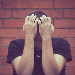 Image showing portrait one sad man standing near a wall