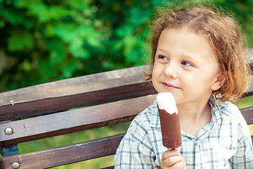 Image showing little boy eating ice cream in the park