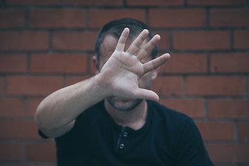 Image showing portrait one sad man standing near a wall