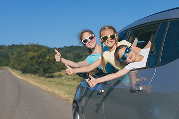 Image showing Happy brother and his two sisters are sitting in the car at the 