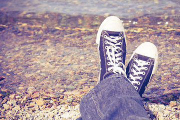 Image showing black sneakers on man legs