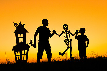 Image showing Happy father and son playing outdoors at the sunset time.