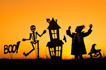 Image showing Happy little boy playing outdoors at the sunset time.