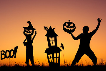 Image showing Happy father and son playing outdoors at the sunset time.