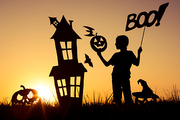 Image showing Happy little boy playing outdoors at the sunset time.