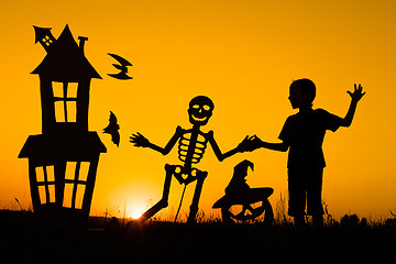 Image showing Happy little boy playing outdoors at the sunset time.