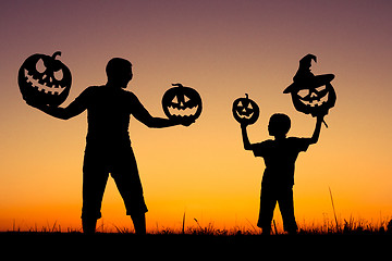 Image showing Happy father and son playing outdoors at the sunset time.