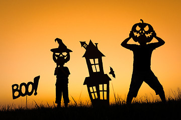 Image showing Happy father and son playing outdoors at the sunset time.