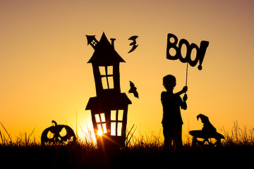 Image showing Happy little boy playing outdoors at the sunset time.