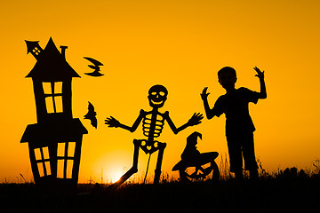 Image showing Happy little boy playing outdoors at the sunset time.