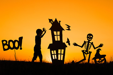 Image showing Happy little boy playing outdoors at the sunset time.