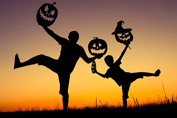 Image showing Happy father and son playing outdoors at the sunset time.