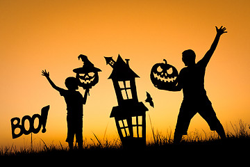 Image showing Happy father and son playing outdoors at the sunset time.