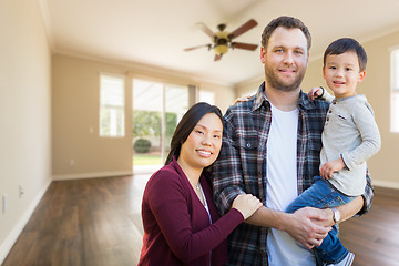 Image showing Mixed Race Chinese and Caucasian Parents and Child Inside Empty 