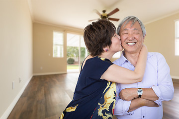 Image showing Happy Senior Chinese Couple Kissing Inside Empty Room Of New Hou