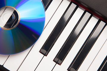 Image showing CD Laying on Piano Keyboards Abstract