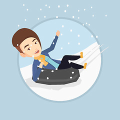 Image showing Woman sledding on snow rubber tube in mountains.