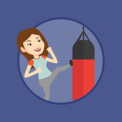 Image showing Woman exercising with punching bag.
