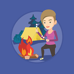 Image showing Woman roasting marshmallow over campfire.