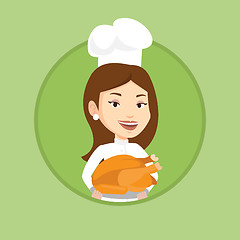 Image showing Chef cook holding roasted chicken.