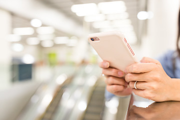 Image showing Woman working on cellphone in a station