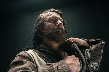 Image showing Portrait of a brutal bald-headed viking in a battle mail posing against a black background.