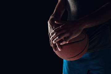 Image showing The hands of a basketball player with ball