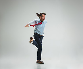 Image showing Businessman running with a briefcase, isolated on gray background