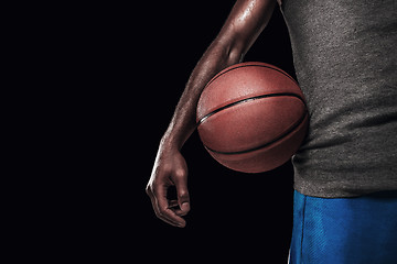 Image showing The hands of a basketball player with ball