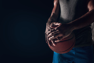 Image showing The hands of a basketball player with ball