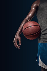 Image showing The hands of a basketball player with ball