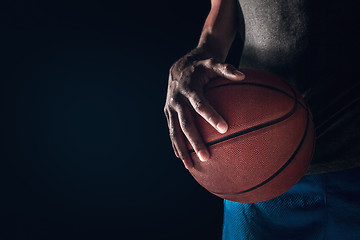 Image showing The hands of a basketball player with ball