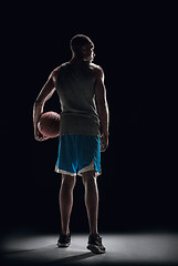 Image showing The back of a basketball player with ball