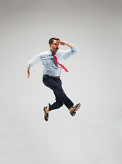 Image showing Businessman running on gray background