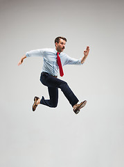 Image showing Businessman running on gray background