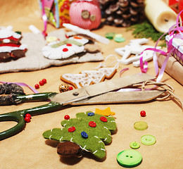 Image showing lot of stuff for handmade gifts, scissors, ribbon, paper with countryside pattern, ready for holiday concept, nobody home 