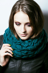 Image showing young pretty real woman in sweater and scarf all over her face s