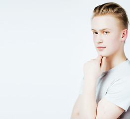 Image showing young handsome teenage hipster guy posing emotional, happy smiling against white background isolated, lifestyle people concept