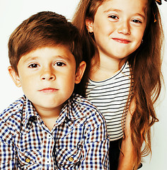 Image showing little cute boy and girl hugging playing on white background, ha