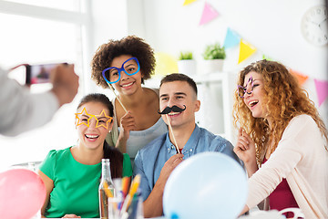 Image showing friends or team photographing at office party