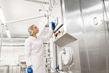 Image showing woman programming computer at ice cream factory